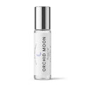 A clear glass perfume oil roller bottle with a reflective silver cap and a white label reading 'ORCHID MOON Perfume Oil' by DST Fragrances, shown on a clean white background.