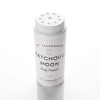A white plastic bottle of Patchouli Moon Body Powder by DST Fragrances, featuring a matching white shaker lid, set against a clean white background with a soft reflection.