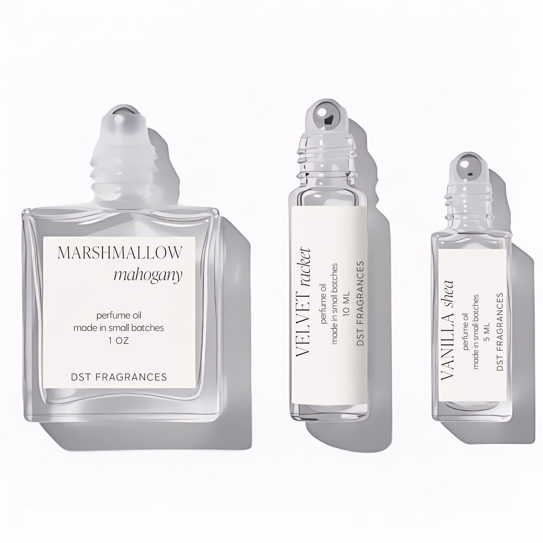 Three capless perfume bottles of Perfume Oil from DST Fragrances in 5ml, 10ml, and 30ml sizes meant to show size comparison and roller ball dispenser on a white background.