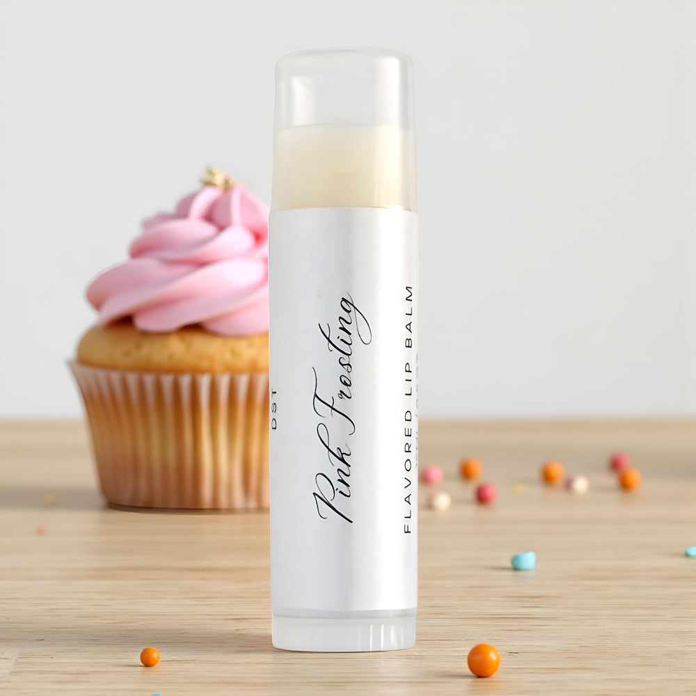 Lip balm labeled 'Pink Frosting' with a cupcake in the background