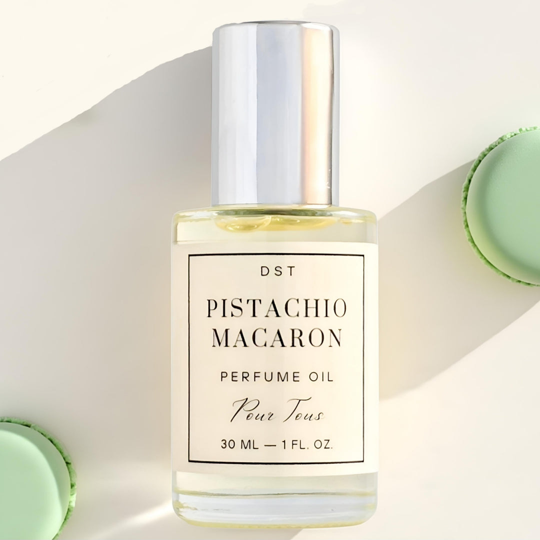 Pistachio Macaron Perfume Oil against an ivory backdrop with green French 