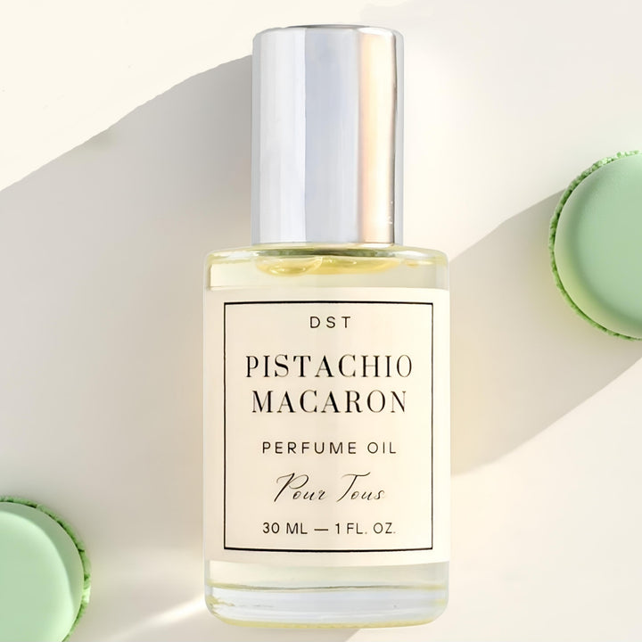 Pistachio Macaron Perfume Oil against an ivory backdrop with green French 