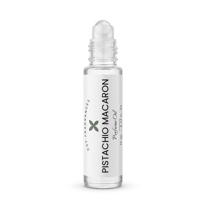 A clear glass rollerball bottle of Pistachio Macaron perfume oil with a white label and a clear cap, shown on a solid white background.