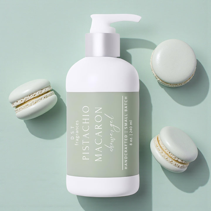 240ml bottle of Pistachio Macaron scented shower gel by DST Fragrances against a mint green background with pistachio french macarons.