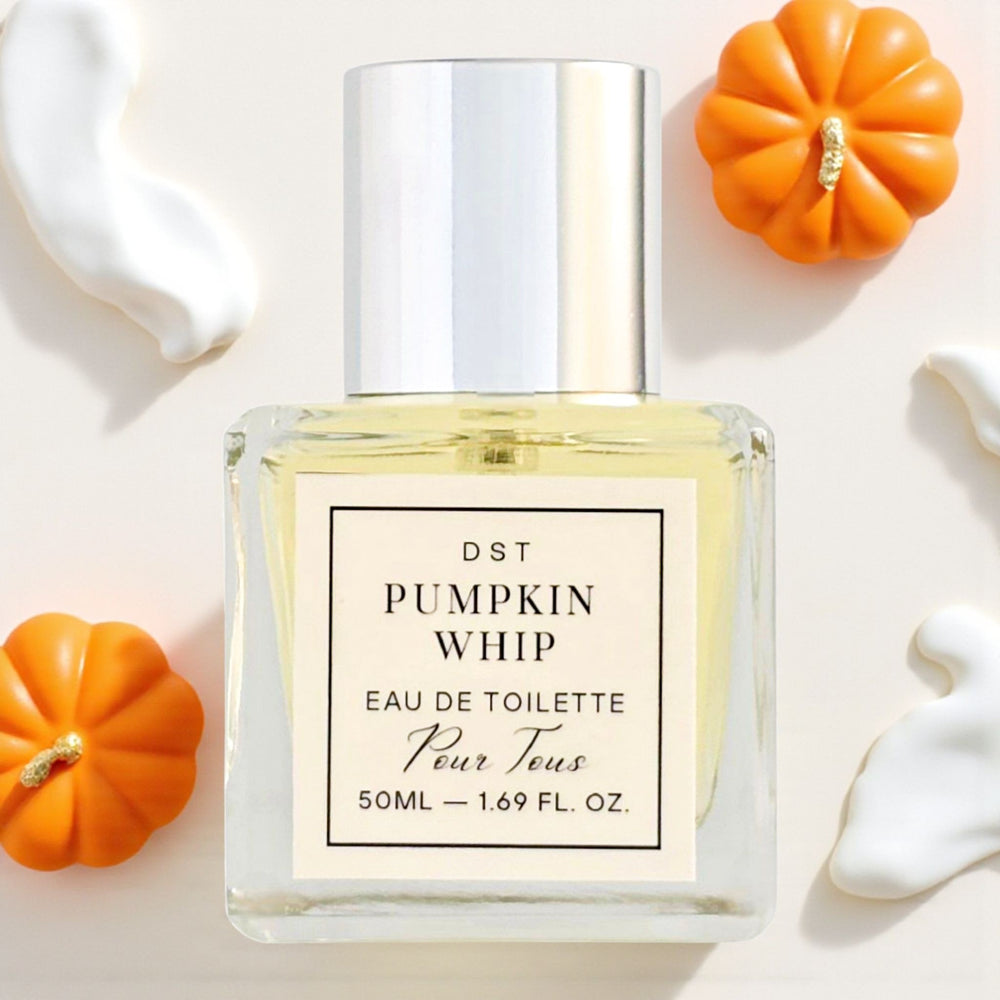 Perfume bottle labeled 'Pumpkin Whip' with small pumpkins on a light background