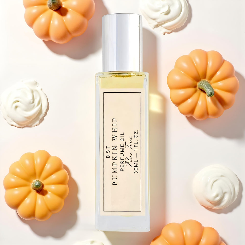 Perfume oil bottle labeled 'Pumpkin Whip' with decorative pumpkins and whipped cream on a light background