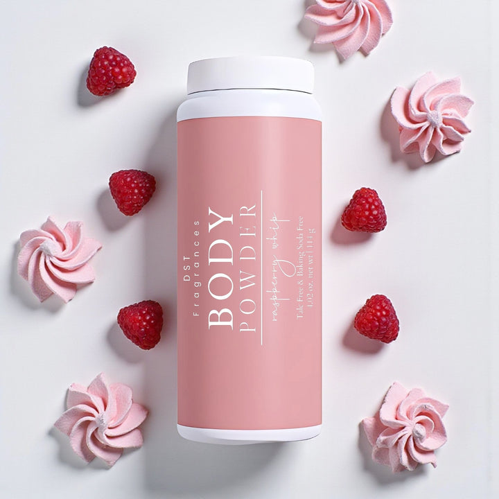 114g Bottle of Raspberry Whip Body Powder by DST Fragrances against a light grey background with fresh raspberries and dollops of pink frosting.