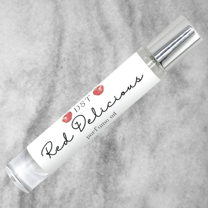 10ml bottle of Red Delicious perfume oil against a grey background. 