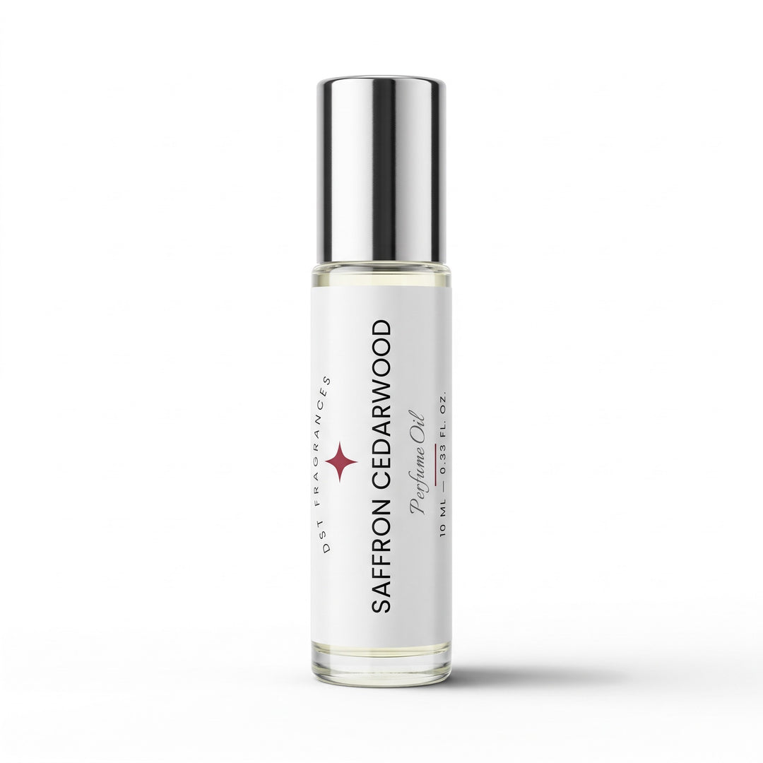A clear glass rollerball bottle of Saffron Cedarwood prelude oil with a reflective silver cap and a white label, shown on a clean white background.