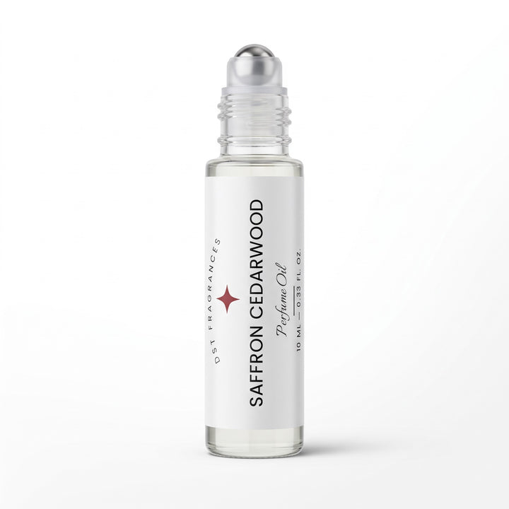 A clear glass rollerball bottle filled with clear fragrance oil, featuring a white label with black text that reads &