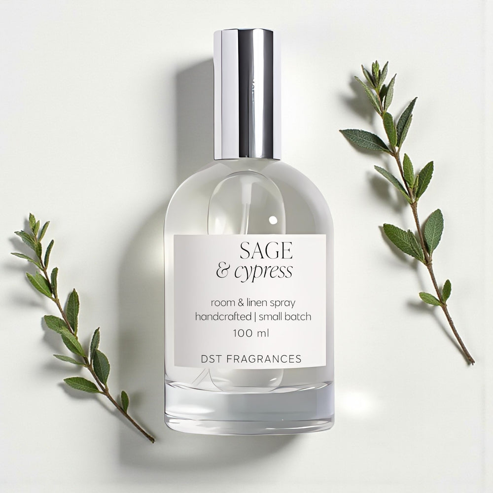 Room and linen spray bottle labeled 'Sage & Cypress' with green leaves on a light background