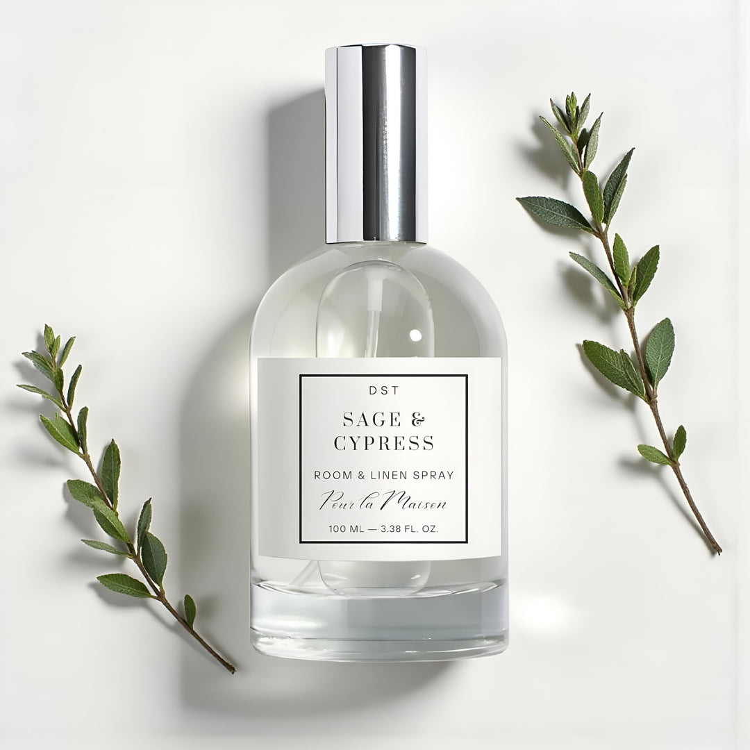 Room and linen spray bottle labeled 'Sage & Cypress' with green leaves on a light background