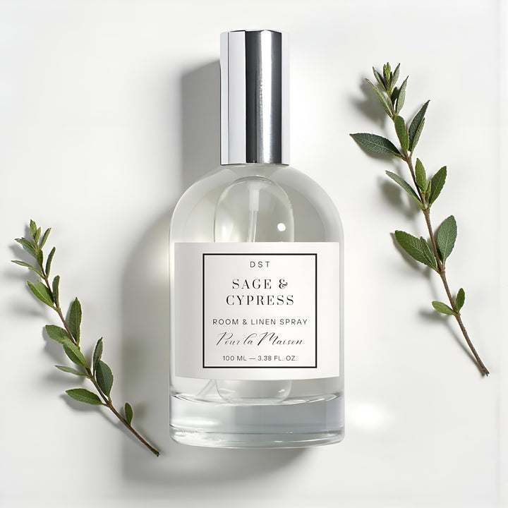 Room and linen spray bottle labeled 'Sage & Cypress' with green leaves on a light background