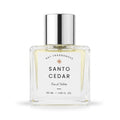 A 50 ml clear glass bottle of DST Fragrances Santo Cedar Eau de Toilette, featuring a white label and a reflective silver cap, set against a plain white background.