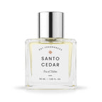 A 50 ml clear glass bottle of DST Fragrances Santo Cedar Eau de Toilette, featuring a white label and a reflective silver cap, set against a plain white background.