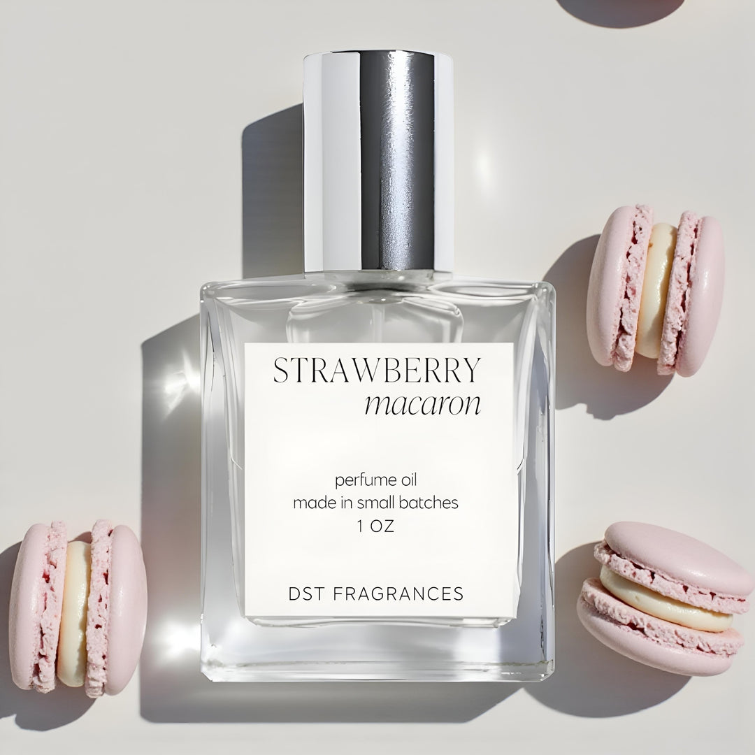 30ml bottle of Strawberry Macaron perfume oil by dst fragrances on an ivory background surrounded by pin french macarons.