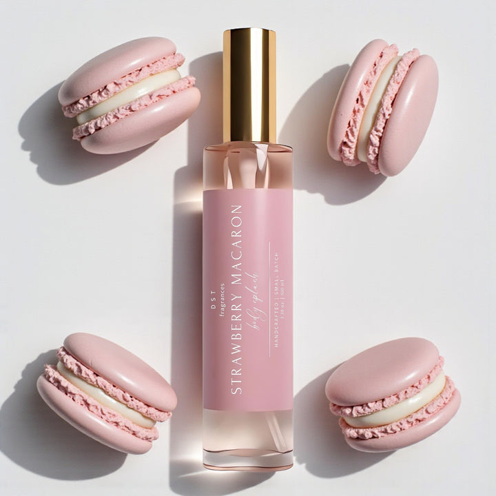 100ml bottle of Strawberry Macaron scented body splash by DST Fragrances against a white background with pink french macarons.
