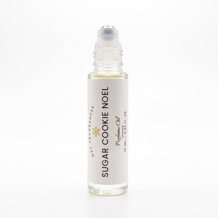 10ml bottle of Sugar Cookie Noel perfume oil by DST Fragrances against a white background. The top is removed to show rollerball dispenser.