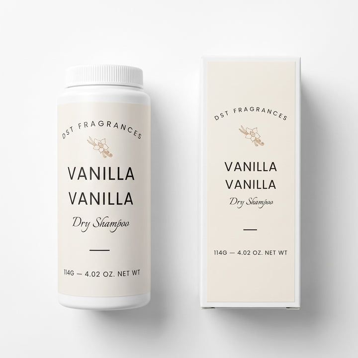 A white plastic bottle of DST Fragrances Vanilla Vanilla Dry Shampoo next to its cream-colored packaging box, displayed on a clean white background.