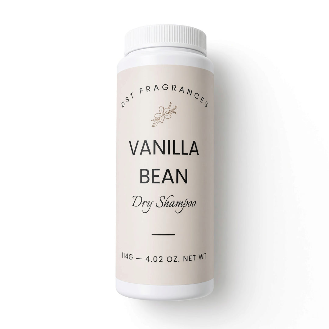 A white plastic bottle of DST Fragrances Vanilla Bean Dry Shampoo, featuring a light beige label with black text, set against a clean white background.