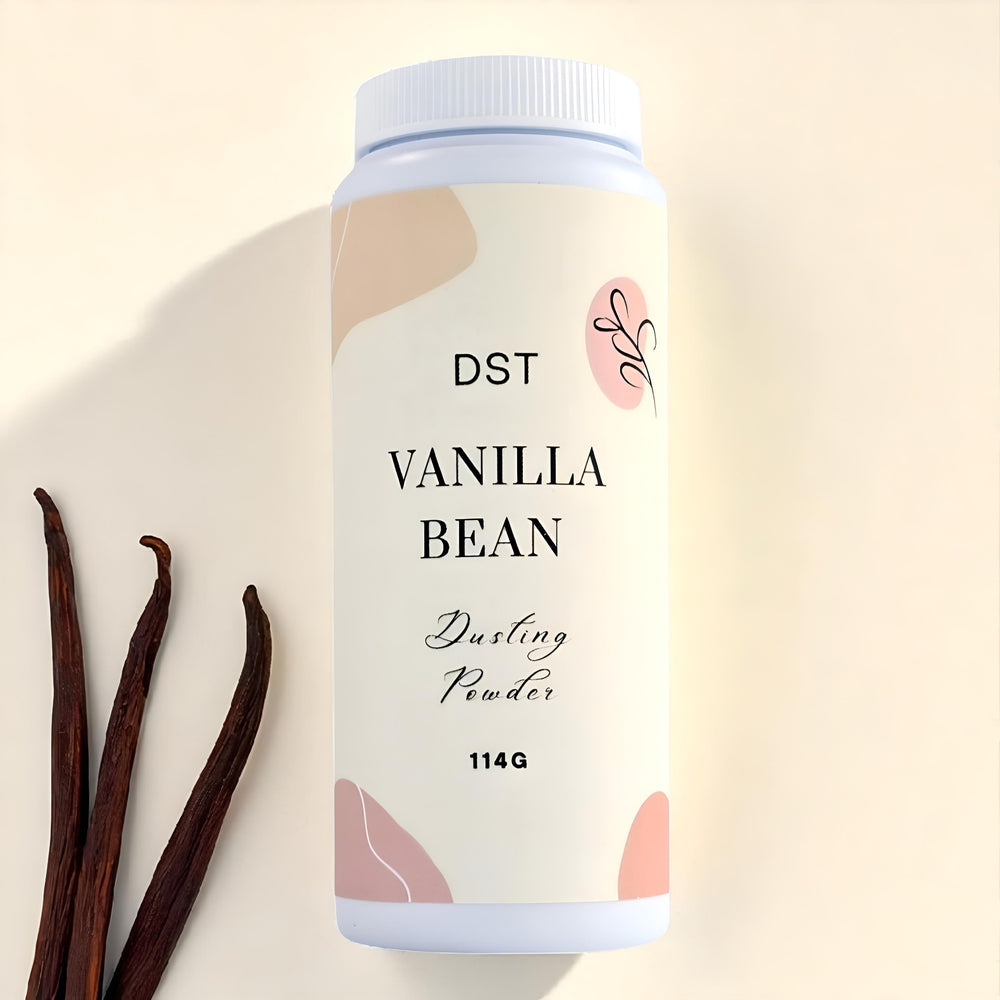 Vanilla bean dusting powder container with vanilla beans on a beige background
