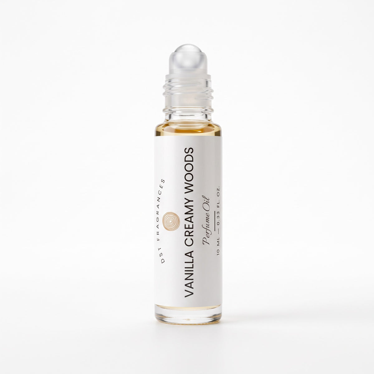 A 10 ml glass rollerball bottle of Vanilla Creamy Woods perfume oil by DST Fragrances, featuring a white label and clear cap, on a seamless white background.