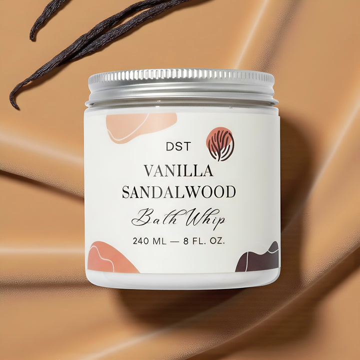 Vanilla sandalwood bath whip container with vanilla beans on a brown background