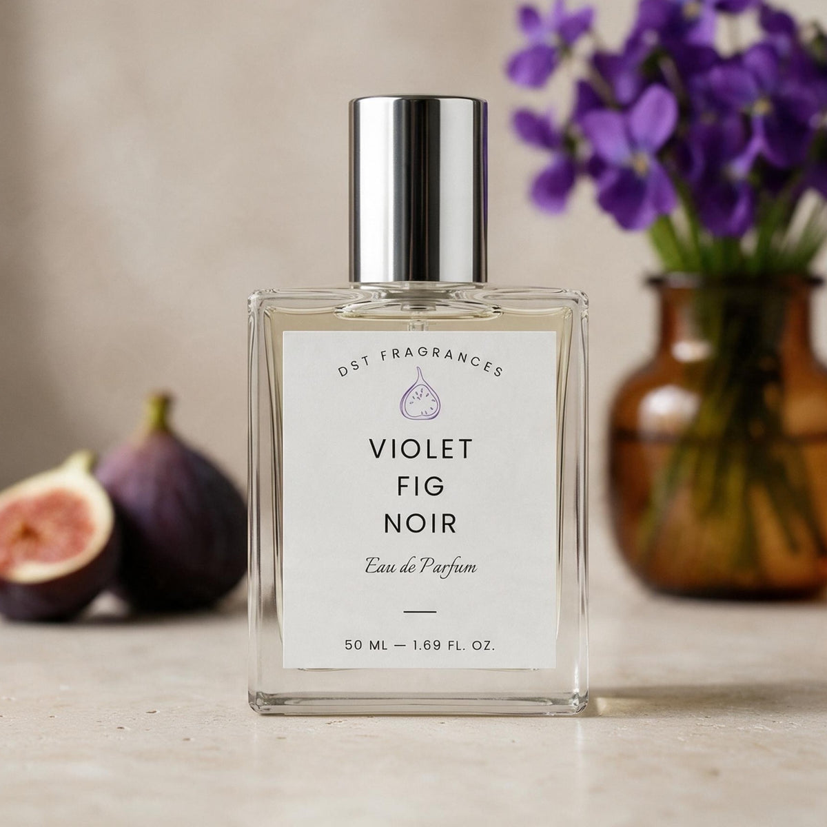 A hand holds a bottle of Violet Fig Noir Eau de Parfum by Dust Fragrances next to fresh figs and scattered purple petals on a marble surface.