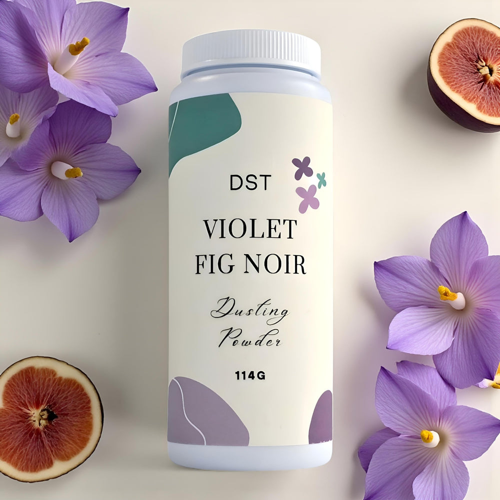 Bottle of DST Violet Fig Noir dusting powder with purple flowers and figs on a light background