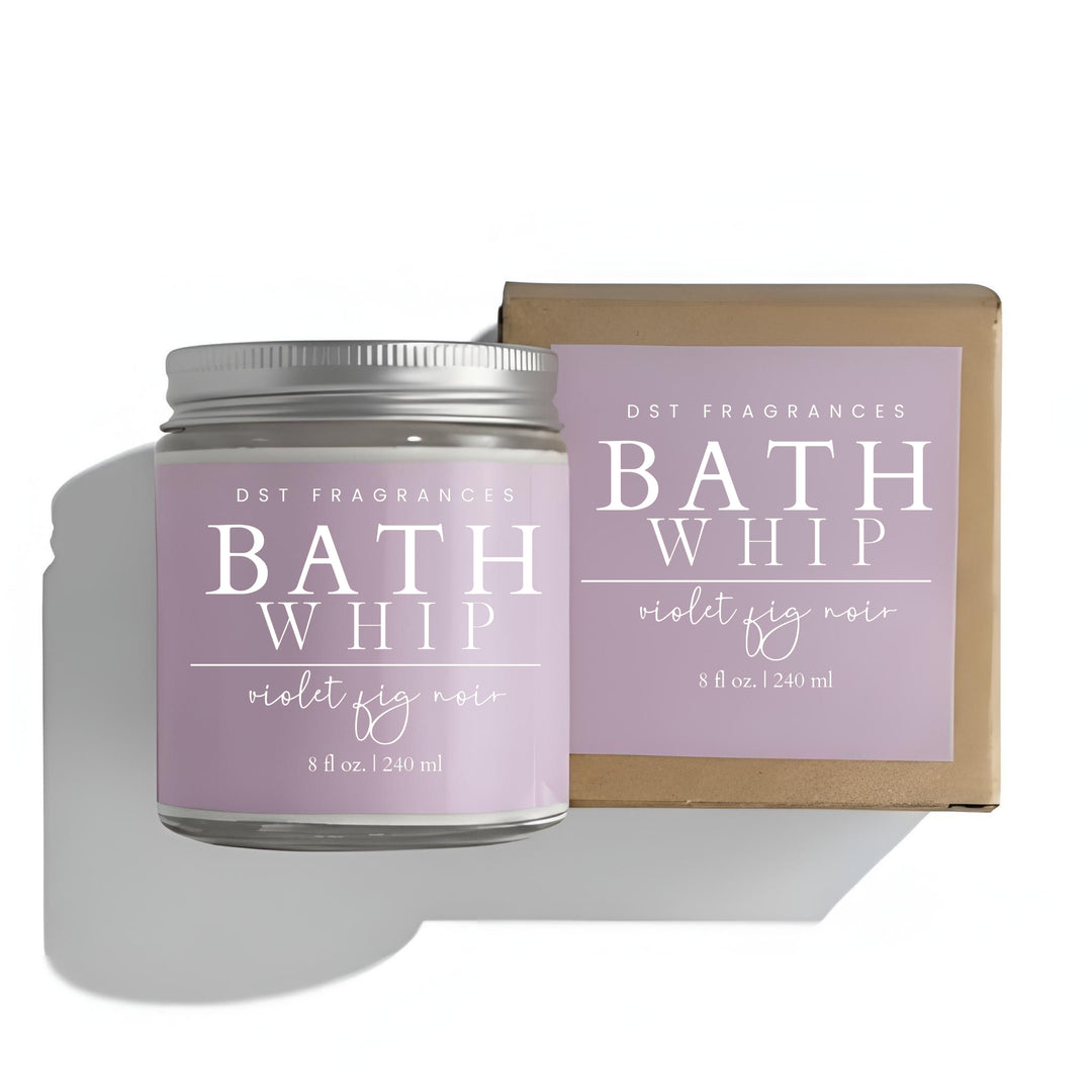 Bath Whip candle with purple label and silver lid on a white background