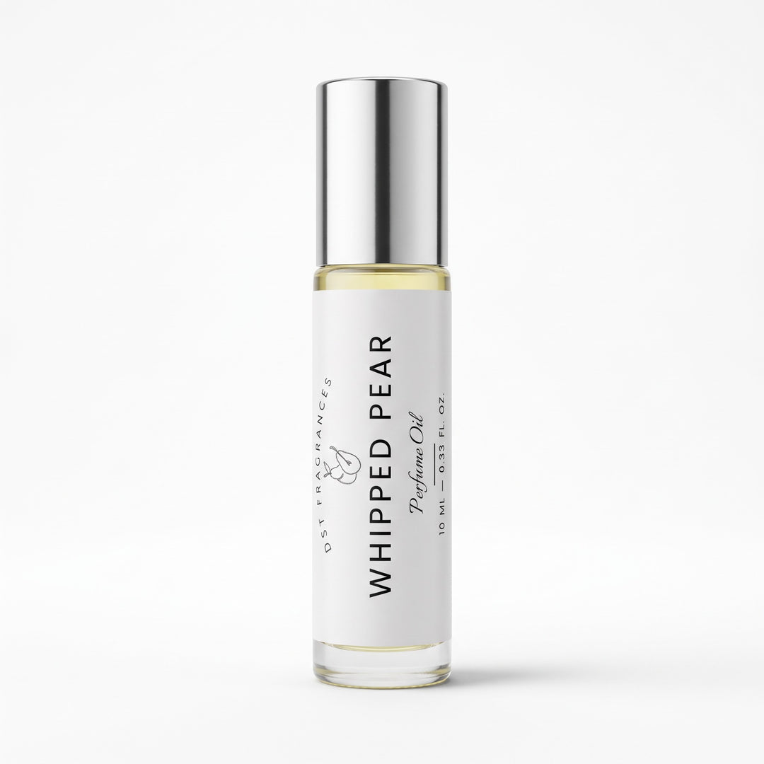 A 10 ml glass roller bottle of Whipped Pear Perfume Oil by DST Fragrances featuring a white label and a reflective silver cap, set against a clean white background.