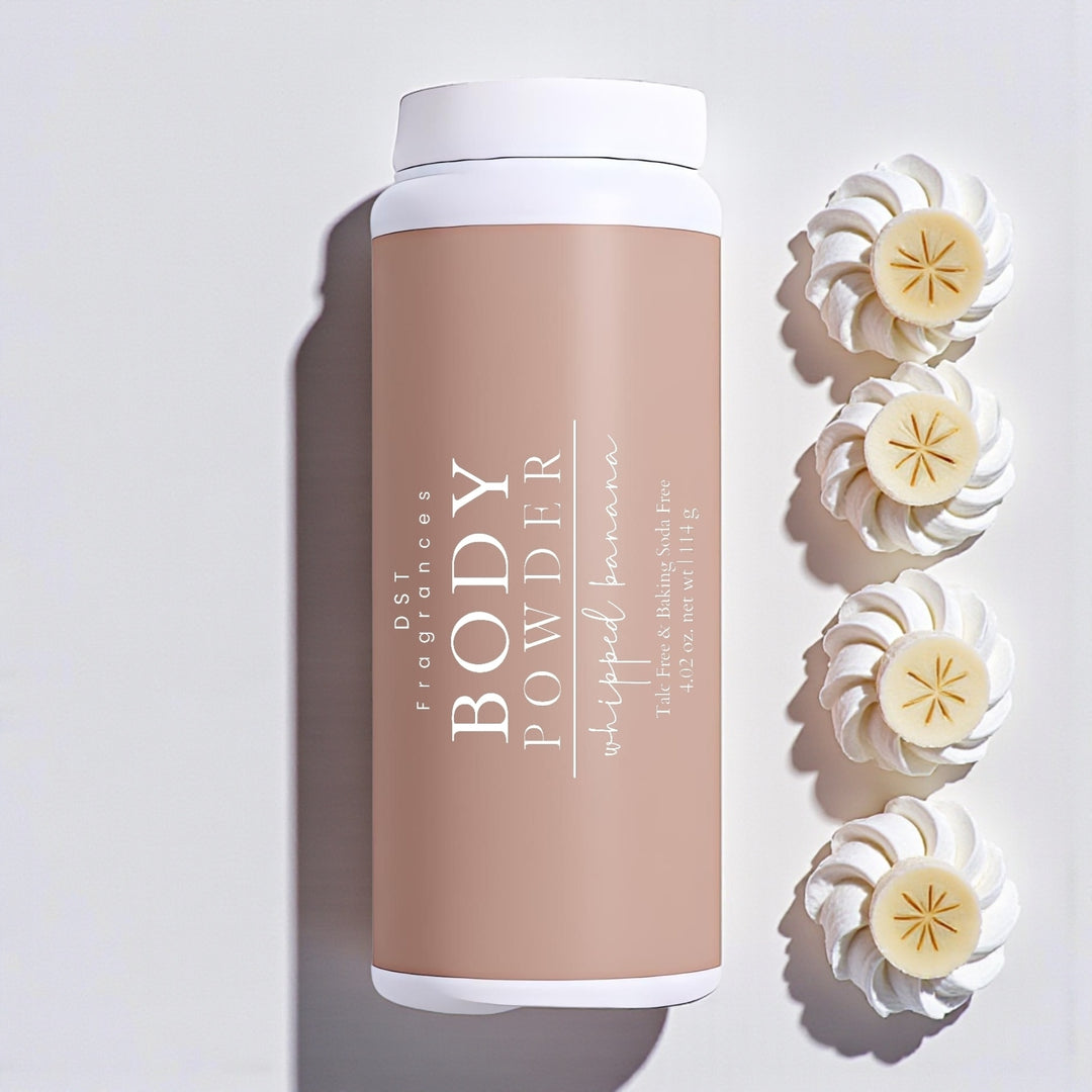 114g bottle of Whipped Banana scented body powder by DST Fragrances against a white background with sliced bananas sitting on dollops of whipped cream.