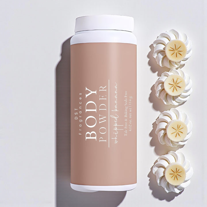114g bottle of Whipped Banana scented body powder by DST Fragrances against a white background with sliced bananas sitting on dollops of whipped cream.