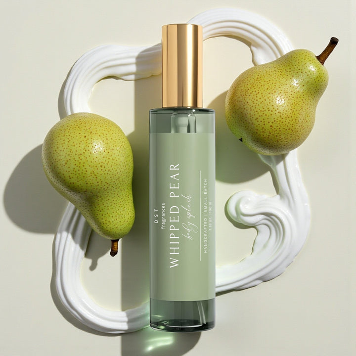 100ml bottle of Whipped Pear scented Body Splash by DST Fragrances against a white background with pears and dollops of white whipped cream.
