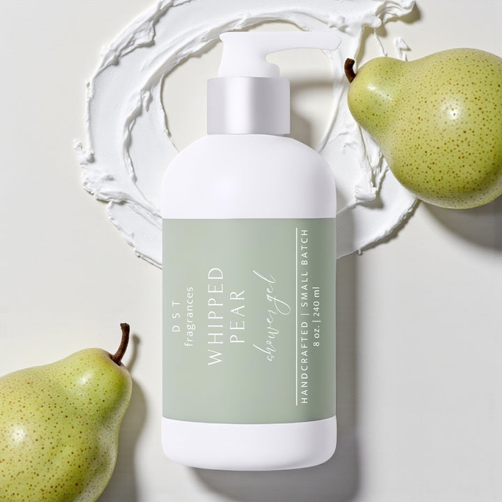 8oz bottle of Whipped Pear scented Shower Gel by DST Fragrances against a white background with pears and dollops of white whipped cream.