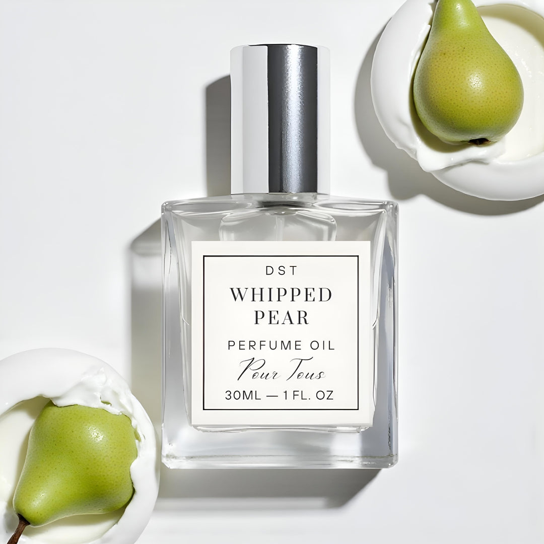 Perfume oil bottle labeled 'Whipped Pear' with pears on a white background