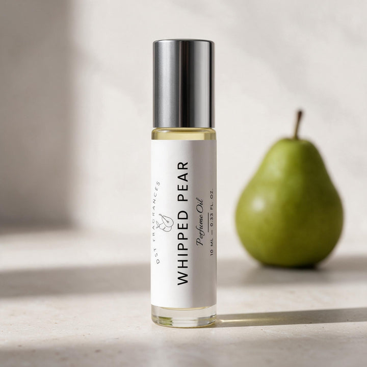 A clear glass perfume oil bottle with a silver cap and a white label reading &